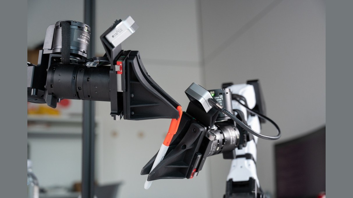 Source photo of XDOF robot arms manipulating a pen and cap
