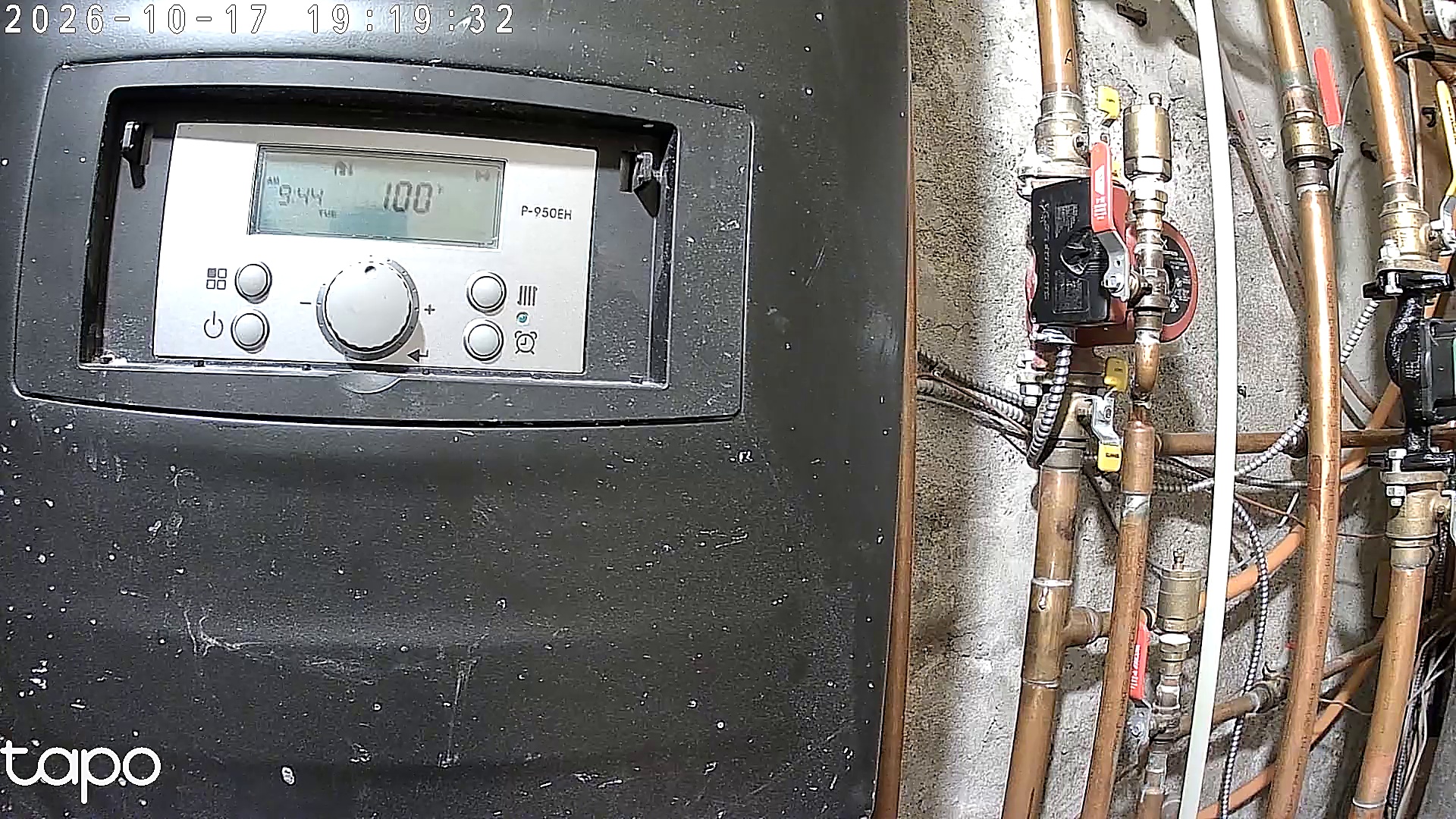 The maker’s camera frame of the boiler and pipes; its display reads 100°F and retains the camera’s timestamp.
